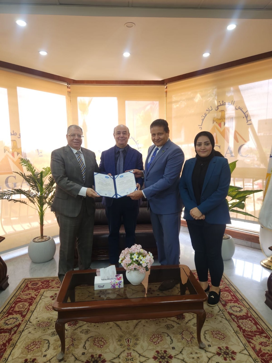 Eng. Mohamed Hassan presenting the EGAC accreditation certificate to Dr. Mostafa Sherbiny